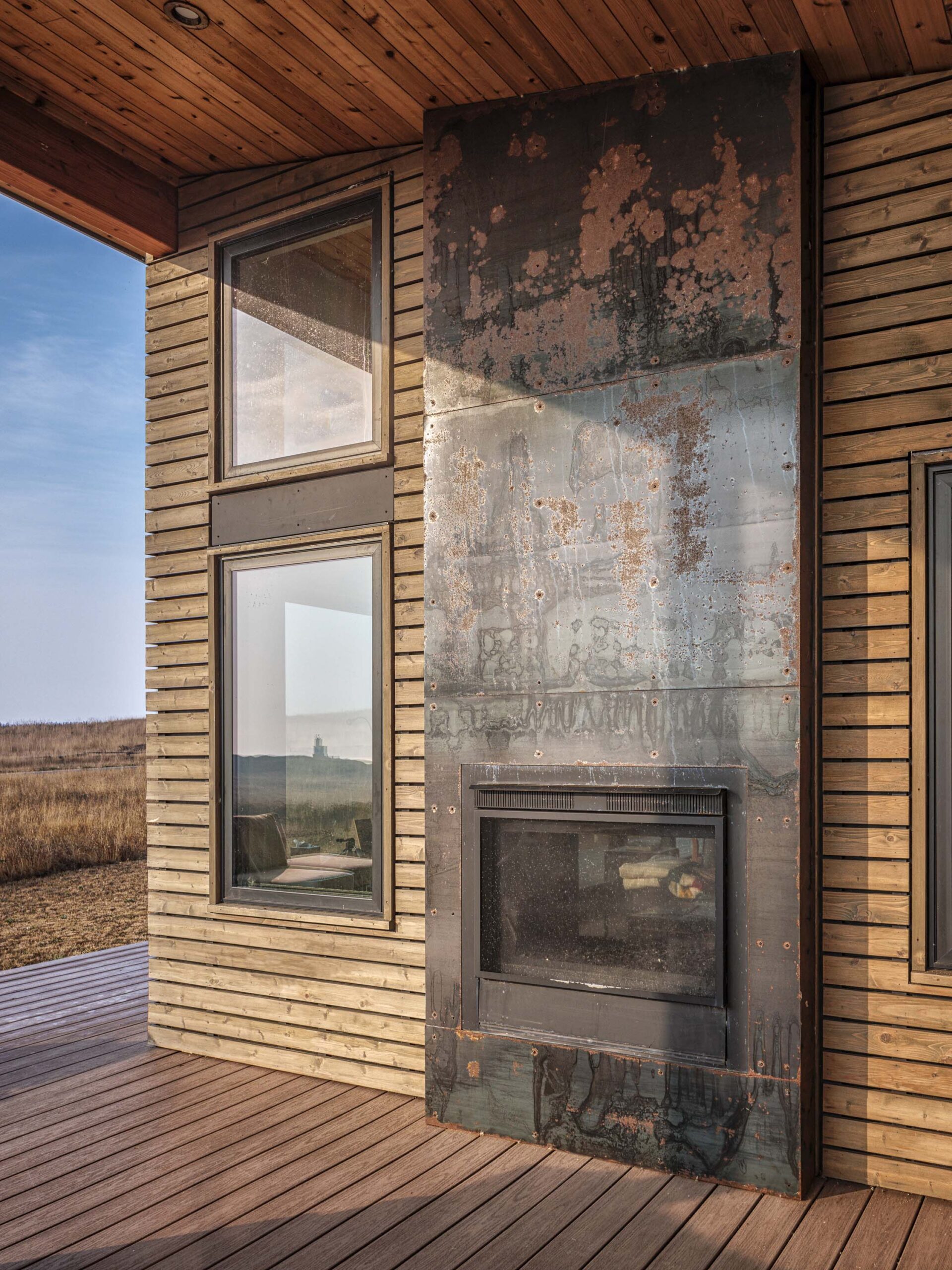 Cattle Point Cabin Exterior Fireplace in San Juan Islands, Custom Home Design by BellCraft Architects